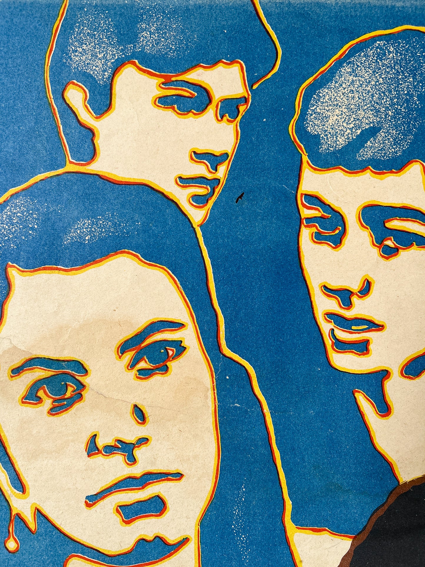 Abstract detail of original soviet movie poster with stylised faces on a blue background
